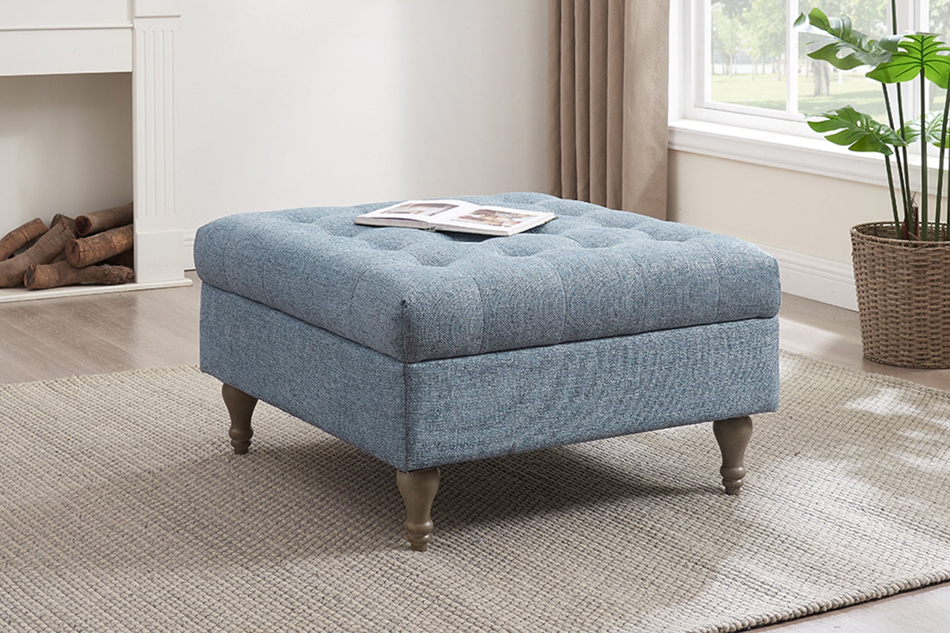 Tufted button-top storage ottoman in blue fabric with wooden legs